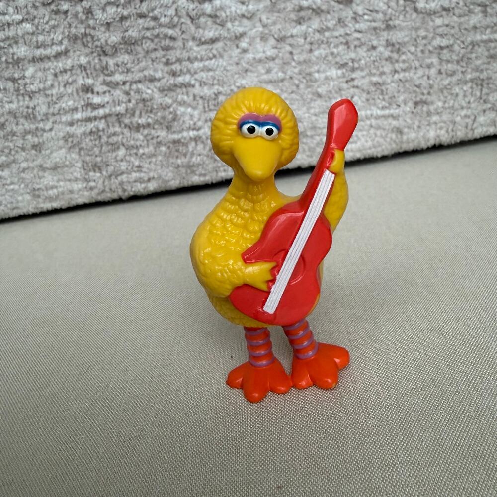 vintage 1982 Tara Toy Sesame Street Big Bird PVC figurine holding a red guitar